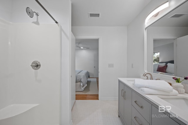 ensuite bathroom with a shower, visible vents, and ensuite bath