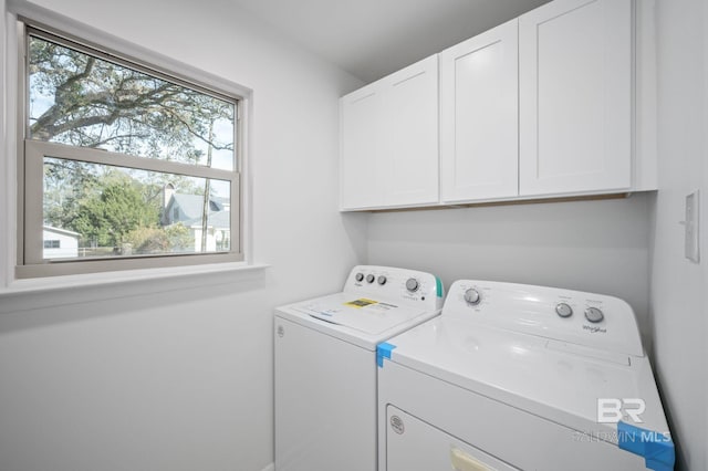 laundry room with cabinet space and washing machine and dryer