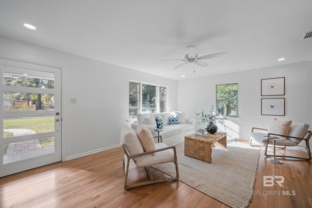 living room with recessed lighting, baseboards, plenty of natural light, and hardwood / wood-style flooring
