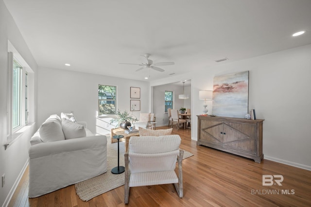 living room with recessed lighting, baseboards, light wood-style flooring, and a ceiling fan