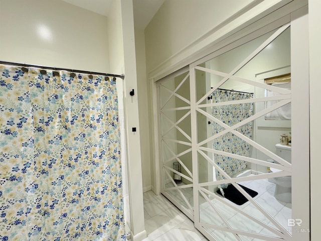 900 Hand Ave, Bay Minette, AL 36507 - full bathroom featuring curtained shower and marble look tiles