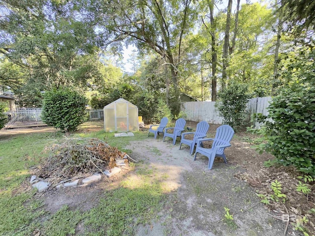 900 Hand Ave, Bay Minette, AL 36507 - fenced backyard with a greenhouse and an outdoor structure
