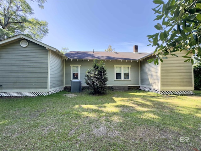 900 Hand Ave, Bay Minette, AL 36507 - back of house featuring central AC, a lawn, and a chimney