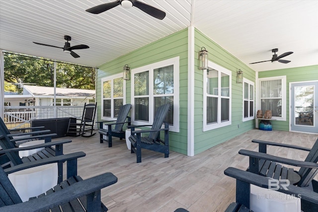 wooden deck with covered porch and ceiling fan