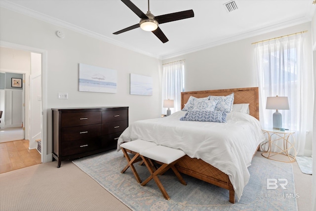 bedroom featuring light wood-type flooring, ceiling fan, and crown molding