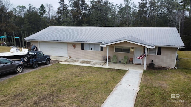 single story home with a garage and a front lawn