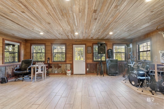 misc room with light hardwood / wood-style floors, wooden walls, and wood ceiling