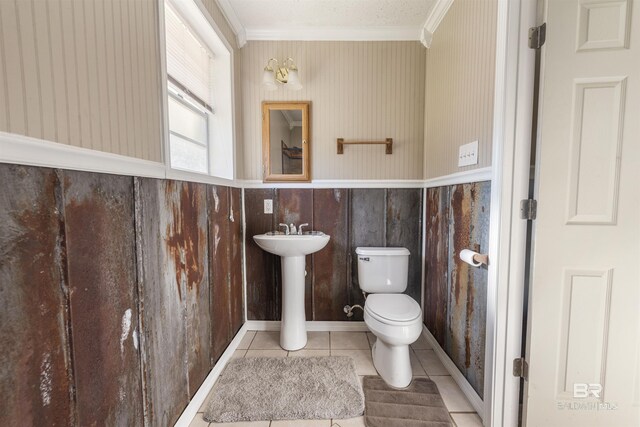 bathroom with tile patterned floors, sink, toilet, and ornamental molding