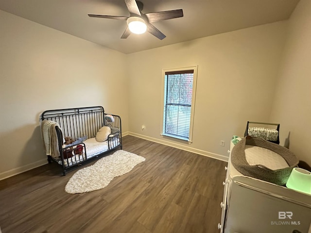 living area with ceiling fan and dark hardwood / wood-style flooring