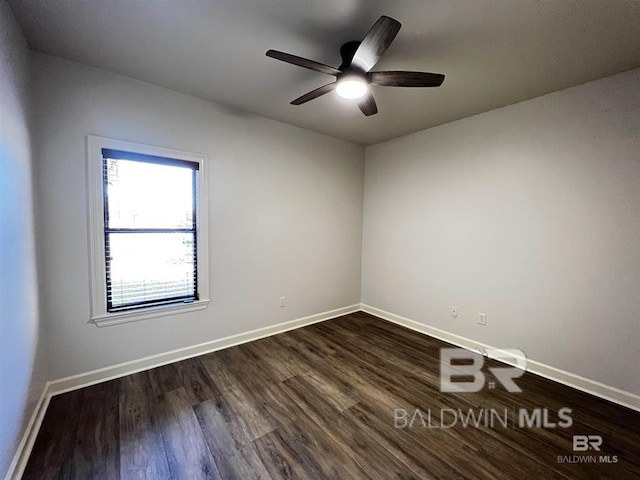 empty room featuring ceiling fan and dark hardwood / wood-style flooring