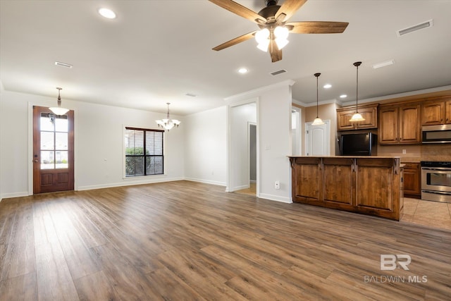 kitchen with ceiling fan with notable chandelier, decorative light fixtures, hardwood / wood-style flooring, stainless steel appliances, and crown molding