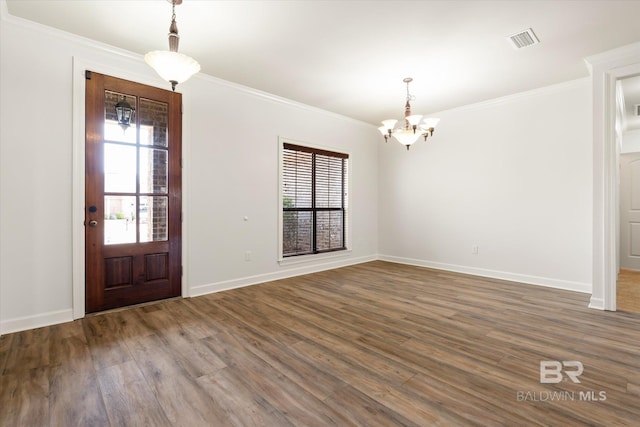 foyer entrance featuring crown molding, a wealth of natural light, and dark hardwood / wood-style floors