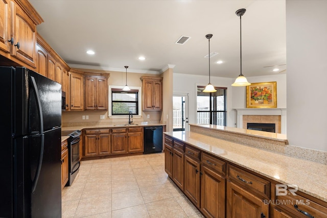 kitchen featuring pendant lighting, sink, light stone counters, black appliances, and light tile patterned flooring