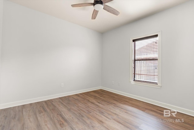 spare room with hardwood / wood-style flooring and ceiling fan