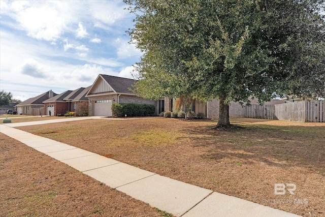 view of front of property featuring a garage and a front lawn