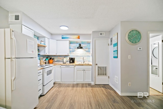 kitchen featuring light hardwood / wood-style flooring, sink, white appliances, white cabinets, and decorative backsplash