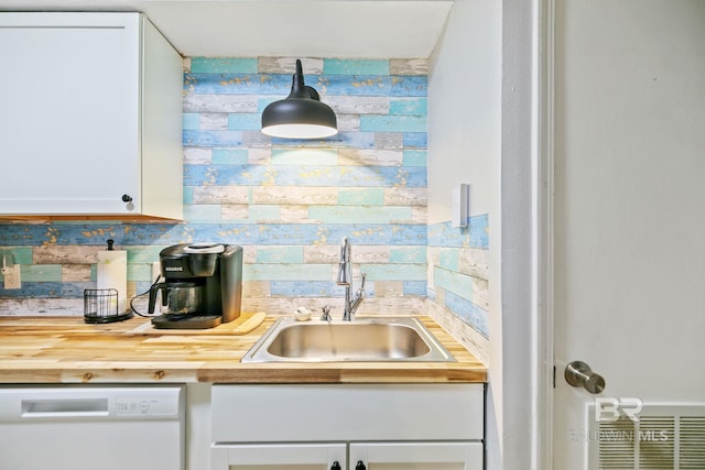 kitchen with sink, white cabinetry, dishwasher, decorative light fixtures, and decorative backsplash