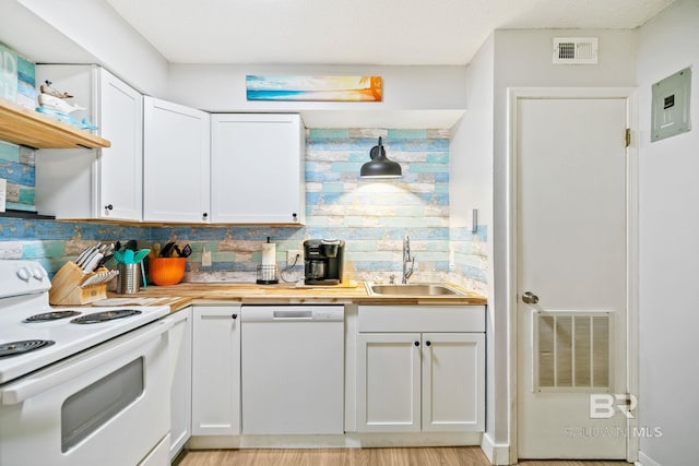 kitchen with light hardwood / wood-style flooring, butcher block counters, white appliances, white cabinets, and sink