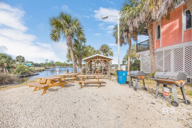 view of property's community with a water view and a gazebo