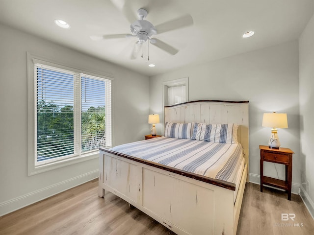 bedroom with ceiling fan and light wood-type flooring