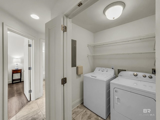 washroom with washer and dryer and light tile patterned floors