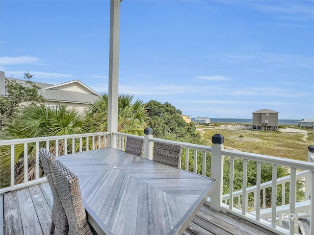 wooden terrace featuring a water view