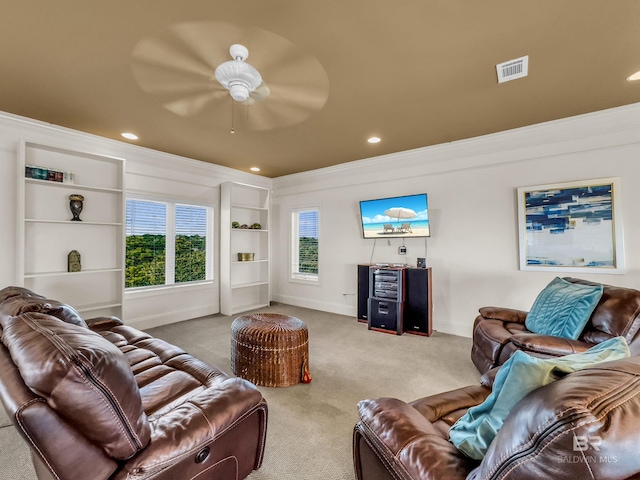 living room featuring ornamental molding, carpet, and ceiling fan