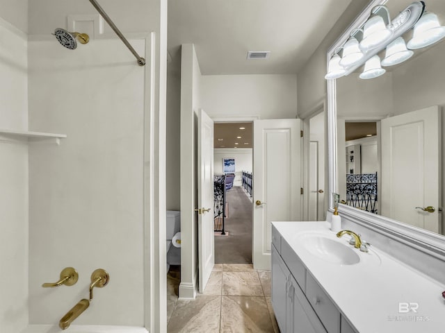 bathroom featuring tile patterned floors, toilet, and vanity