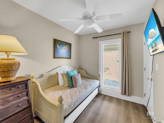 bedroom with dark hardwood / wood-style floors and ceiling fan