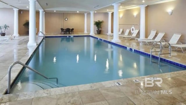 view of pool featuring a hot tub and ornate columns