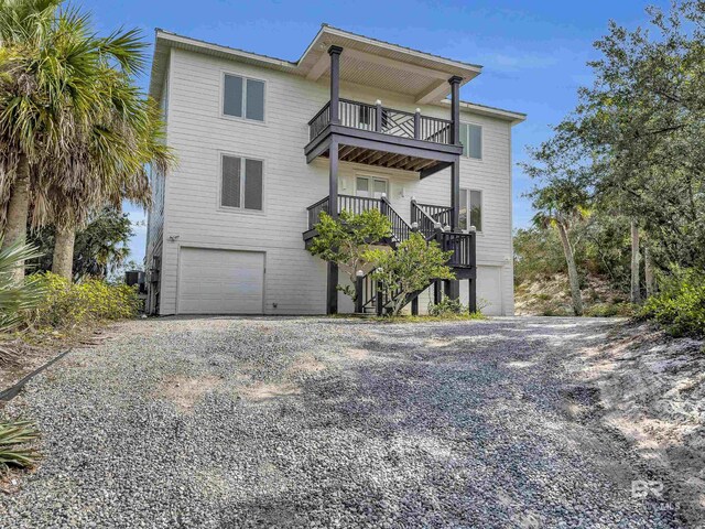 view of front facade featuring a garage and a balcony