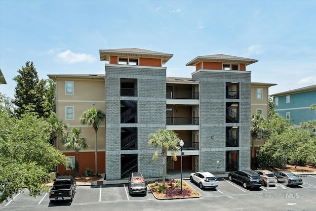 1430 Regency Rd Unit C103, Gulf Shores, AL 36542 - view of building exterior featuring uncovered parking