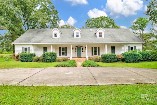 new england style home with a porch and a front lawn