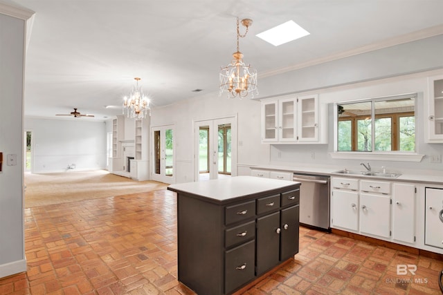 kitchen featuring white cabinetry, ceiling fan with notable chandelier, a kitchen island, dishwasher, and decorative light fixtures