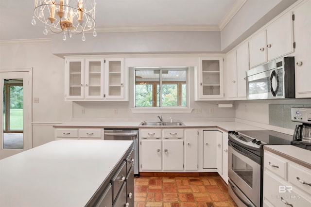 kitchen with white cabinetry, stainless steel appliances, an inviting chandelier, decorative light fixtures, and plenty of natural light