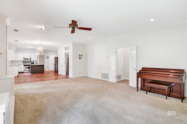 carpeted living room featuring ceiling fan with notable chandelier and crown molding