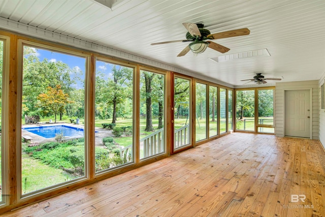 unfurnished sunroom featuring a wealth of natural light and ceiling fan