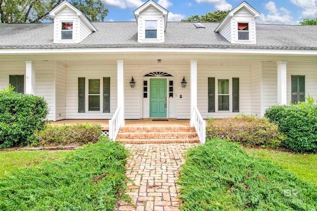 cape cod-style house with a porch