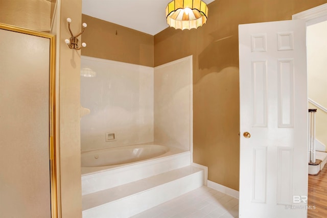 bathroom featuring shower with separate bathtub and hardwood / wood-style floors