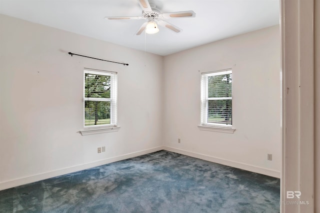 carpeted empty room featuring ceiling fan