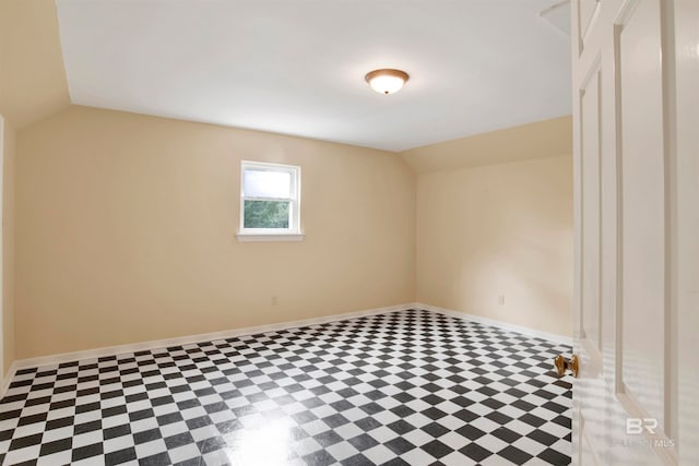 spare room with lofted ceiling