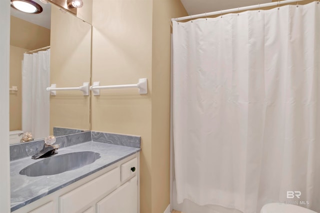 bathroom with vanity, toilet, and a shower with shower curtain