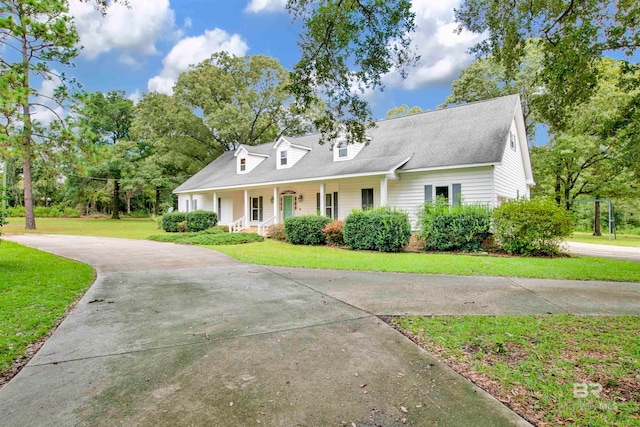 cape cod house featuring a front lawn and a porch