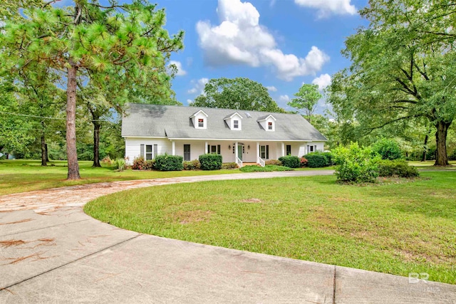 cape cod home with a front lawn and covered porch