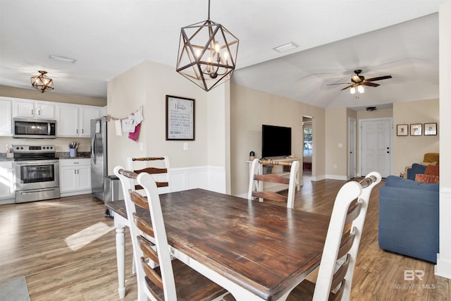 dining room with a ceiling fan and light wood-style floors