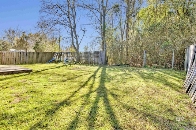 view of yard with a playground and a fenced backyard