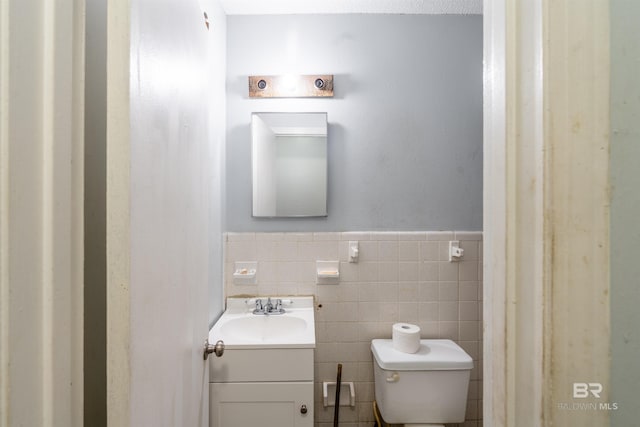 bathroom with tile walls, backsplash, vanity, and toilet