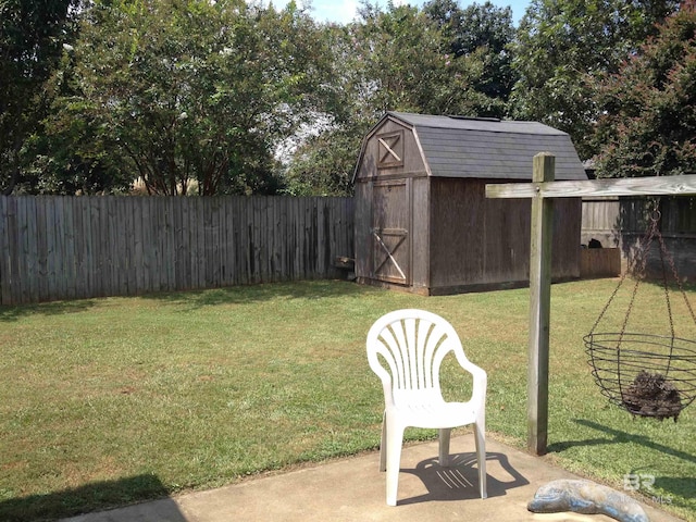 view of yard featuring a fenced backyard, a patio, a storage unit, and an outdoor structure