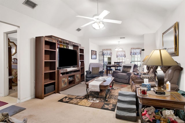 carpeted living area with vaulted ceiling, a ceiling fan, visible vents, and baseboards