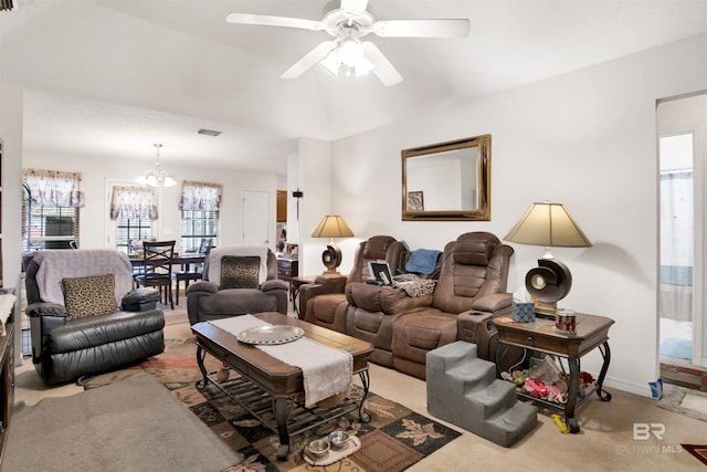 carpeted living area featuring visible vents, ceiling fan with notable chandelier, and baseboards